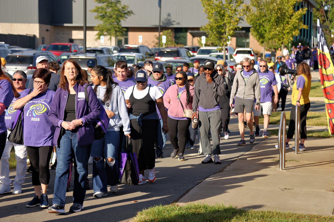 Lions Services supporters walking along the Charlotte Braille Trail at the 2025 Walk