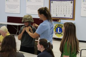 Students curious about our equipment and trying on the helmet.