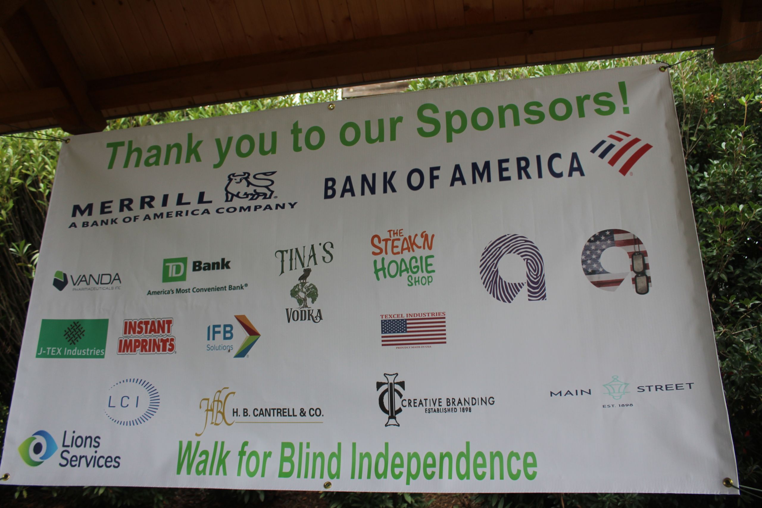 Image is Taken of a Banner that Includes the Sponsor's Logo at the Walk For Blind Independence Event