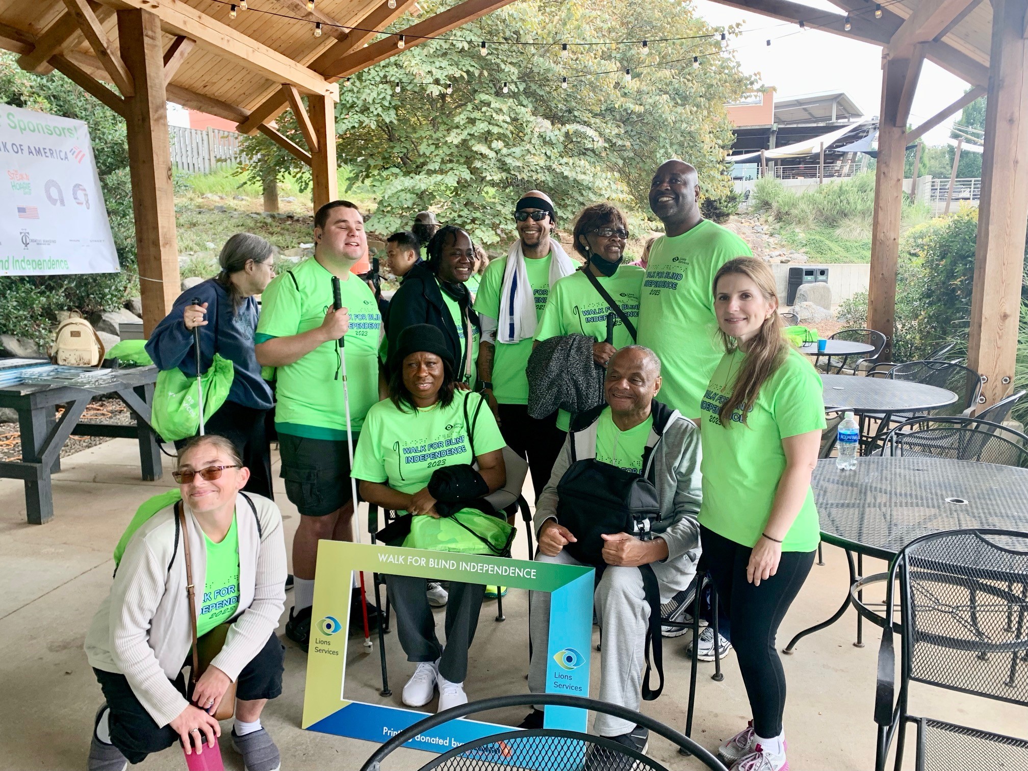 Photo is of a Group In Front of Lions Clean Hand Wash Station