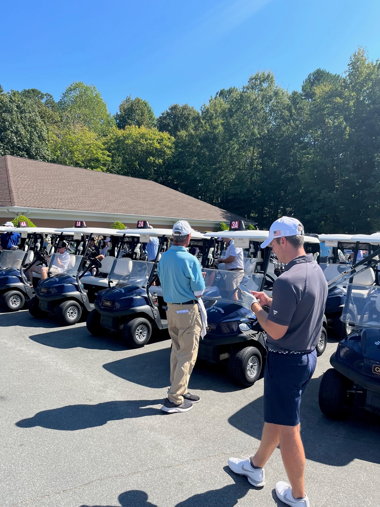 Image Shows Golf Utility Vehicles Lined Up Ready to Head Off to the Golf Course