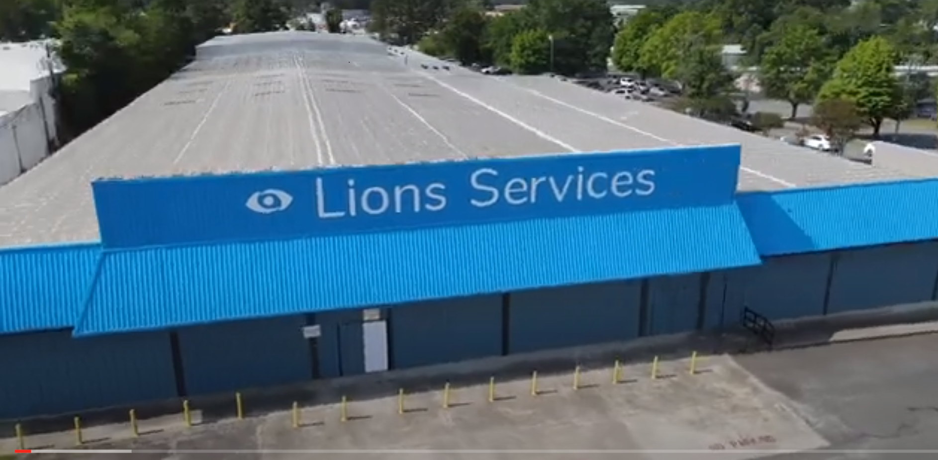 Overhead view of Lions Services Facility. Drone Cam Hovering Over Blue Lions Services Building.
