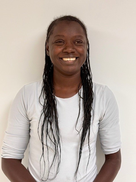 Raven Picture of a female facing the camera and smiling. Wearing a white shirt.